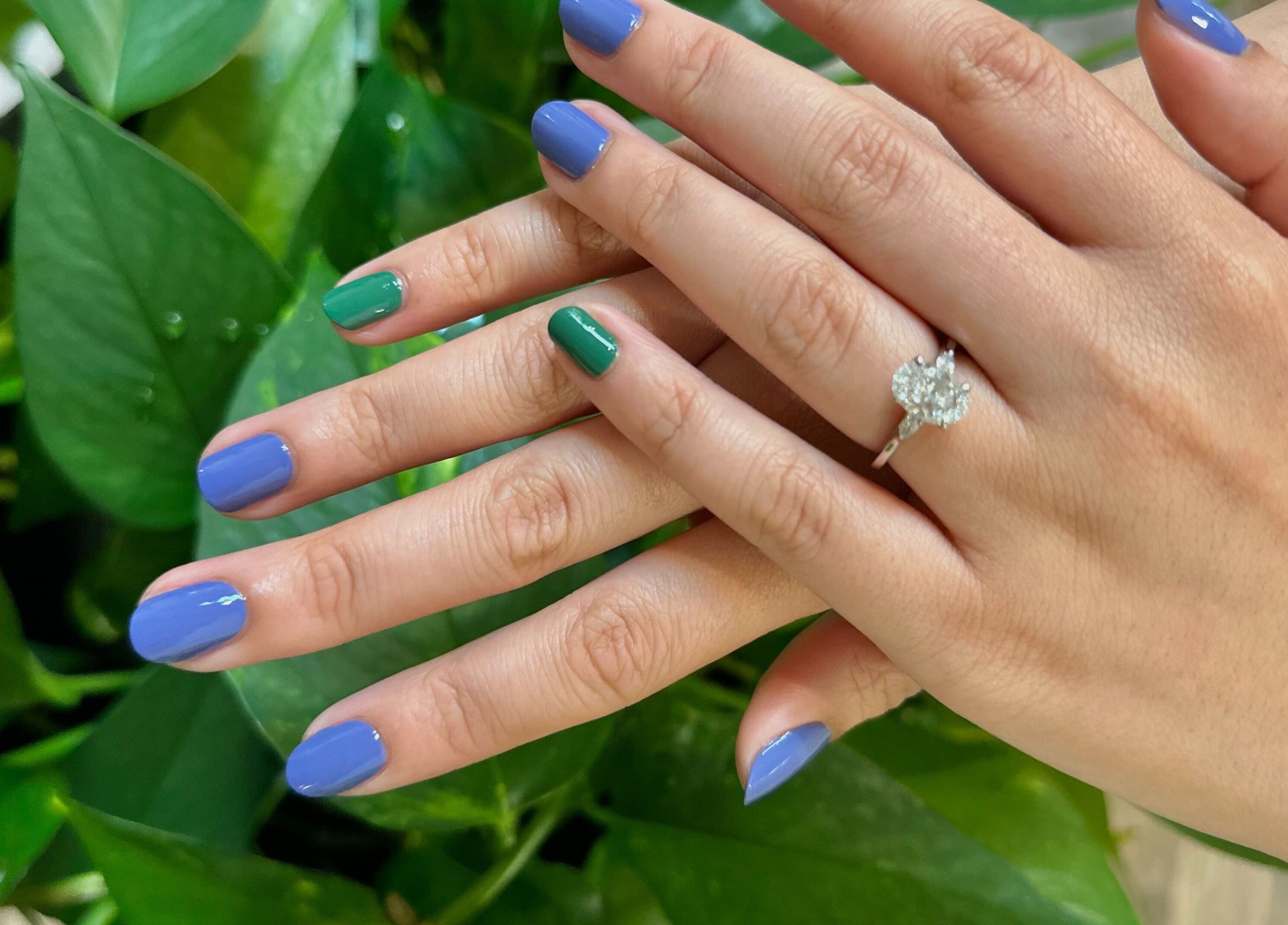 Elegant blue and green manicure with ring showcased at Nails Essential Spa in Cohasset, Massachusetts, US.