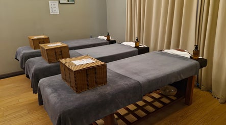 Tranquil massage room at Nón Spa, Đà Nẵng, Đà Nẵng, VN with cozy grey massage tables and warm lighting.