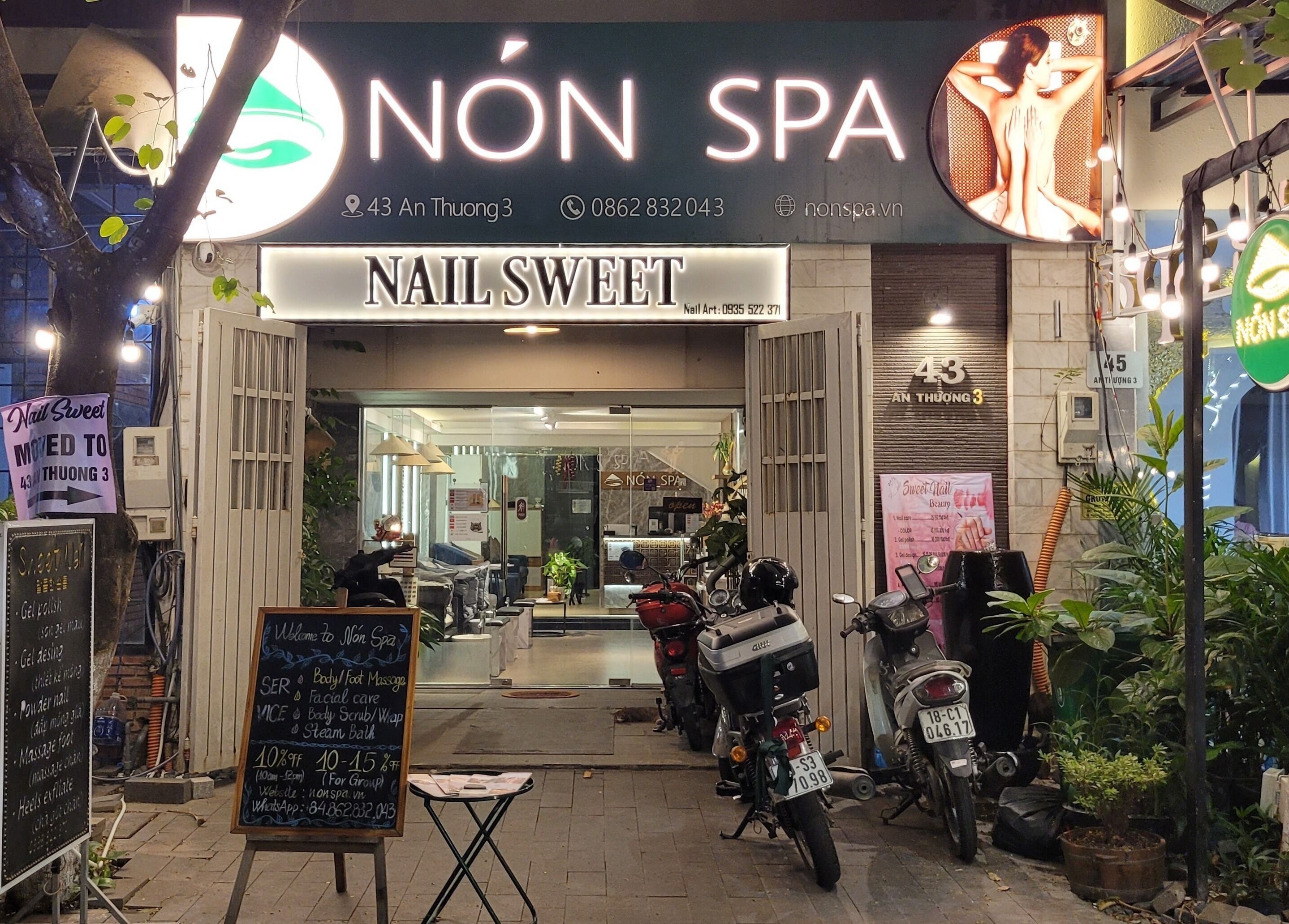 Nón Spa's inviting entrance in Đà Nẵng, Đà Nẵng, VN, highlighted by vibrant signage and greenery.