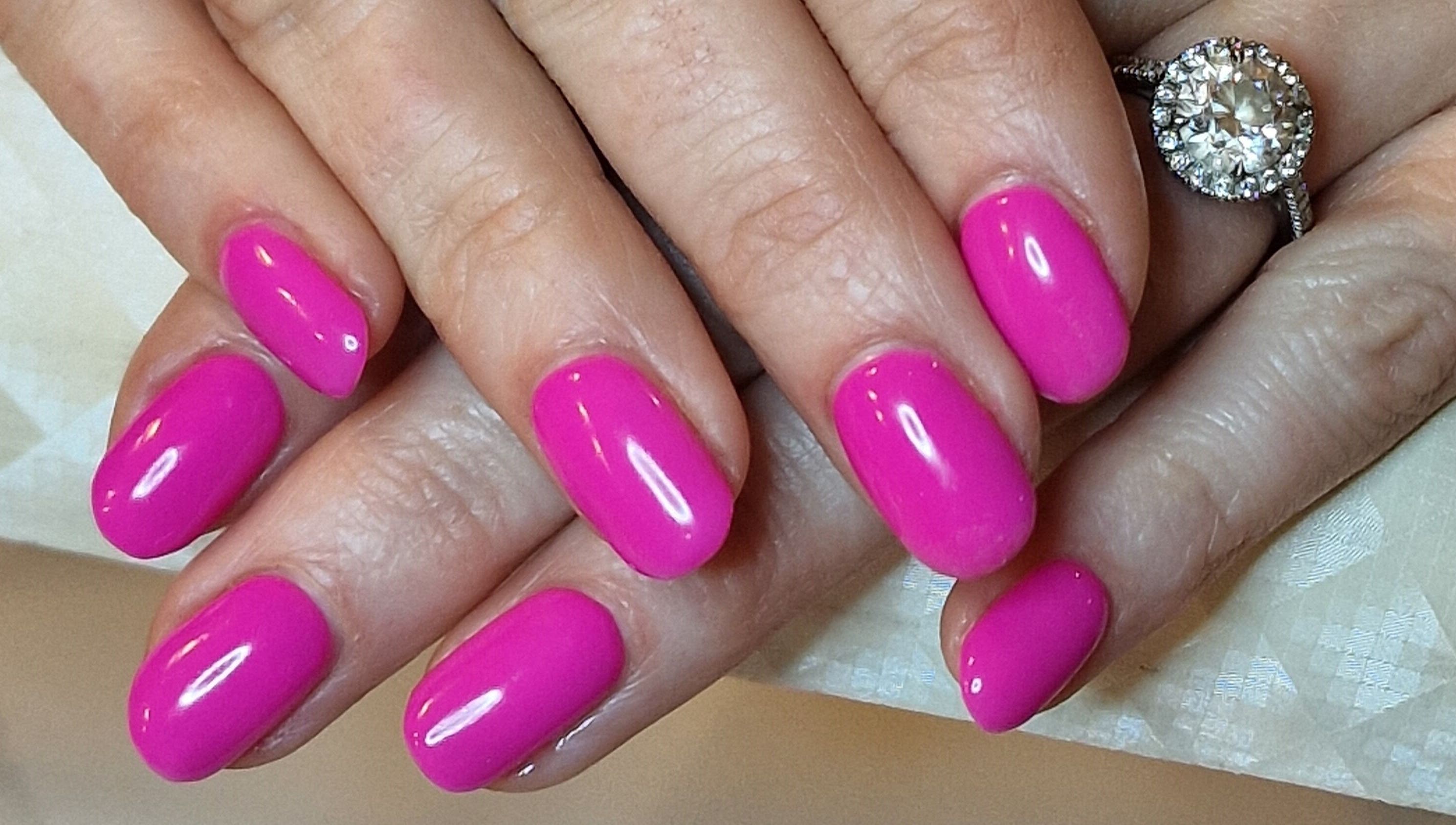 Bright pink manicured nails at Perfectly Polished with Kirsty, Northampton, England, GB.