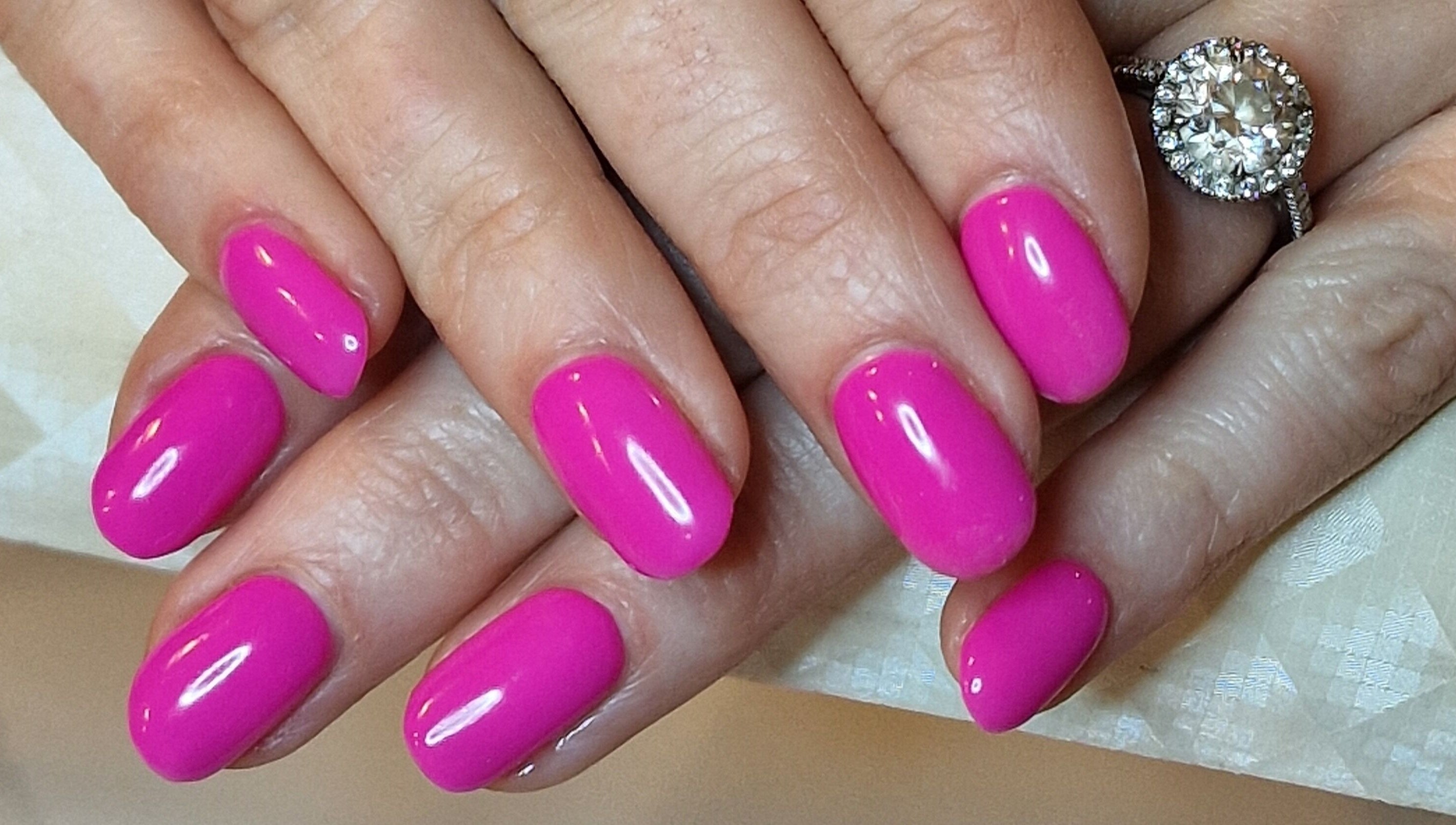 Bright pink manicured nails at Perfectly Polished with Kirsty, Northampton, England, GB.
