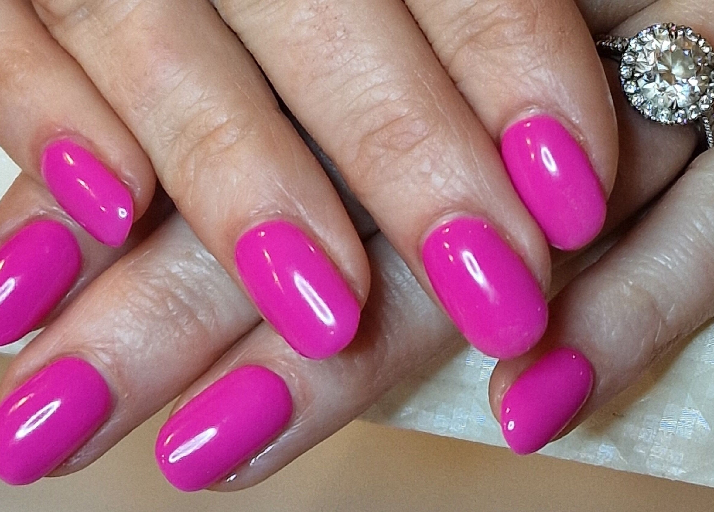 Bright pink manicured nails at Perfectly Polished with Kirsty, Northampton, England, GB.