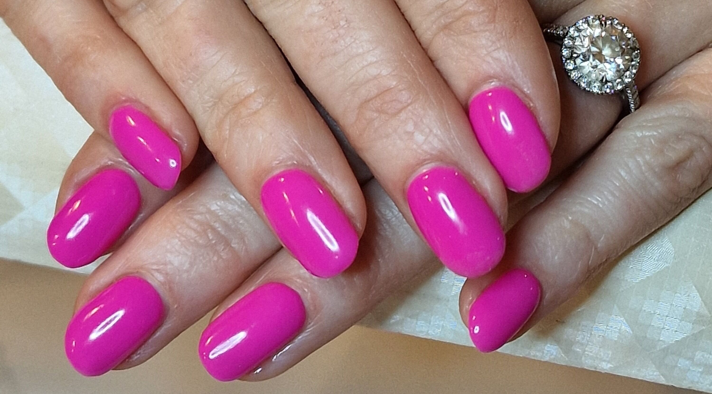 Bright pink manicured nails at Perfectly Polished with Kirsty, Northampton, England, GB.