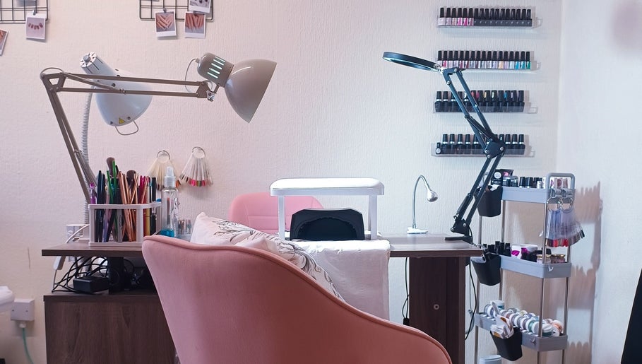 Nail care setup at The Rainbow Studio in Southampton, GB with polish racks and tools on display.