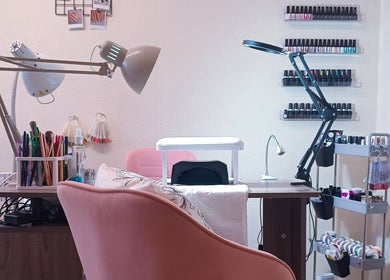 Nail care setup at The Rainbow Studio in Southampton, GB with polish racks and tools on display.
