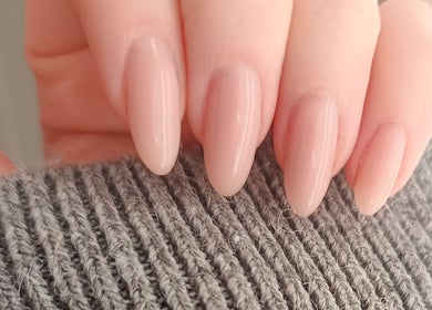 Close-up of manicured nails at The Rainbow Studio, Southampton, GB, showcasing elegant nude polish.
