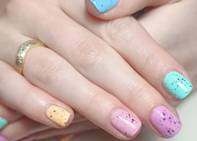 Colorful speckled nail art at The Rainbow Studio, Southampton, GB, showcasing vibrant beauty techniques.