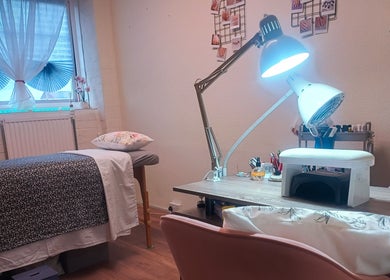 Relaxing treatment room at The Rainbow Studio, Southampton, GB with a massage table and manicure station.