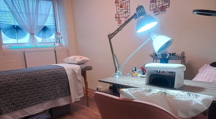 Relaxing treatment room at The Rainbow Studio, Southampton, GB with a massage table and manicure station.