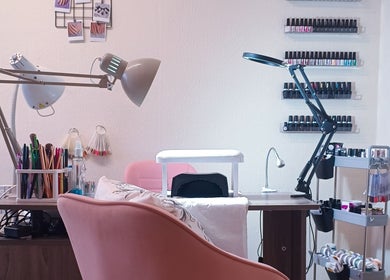 Nail station at The Rainbow Studio, Southampton, GB. Equipped with tools, lamps, and polish for manicure services.