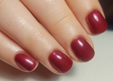 Close-up of elegant crimson nails at The Rainbow Studio, Southampton, GB.