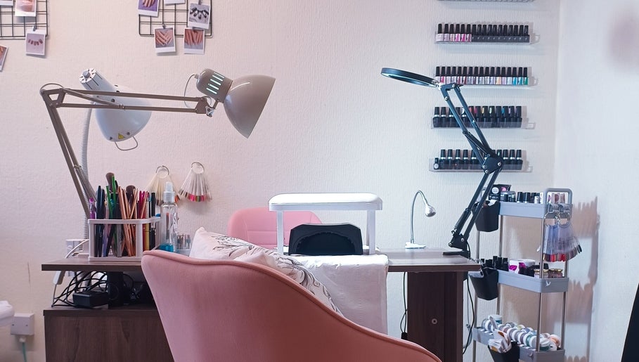Nail treatment station at The Rainbow Studio, Southampton, GB, featuring tools and polish racks.