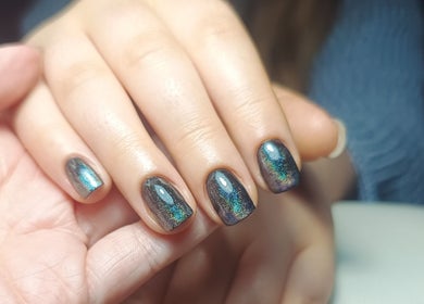 Shimmering nail art at The Rainbow Studio, Southampton, GB, showcasing elegant manicure design.