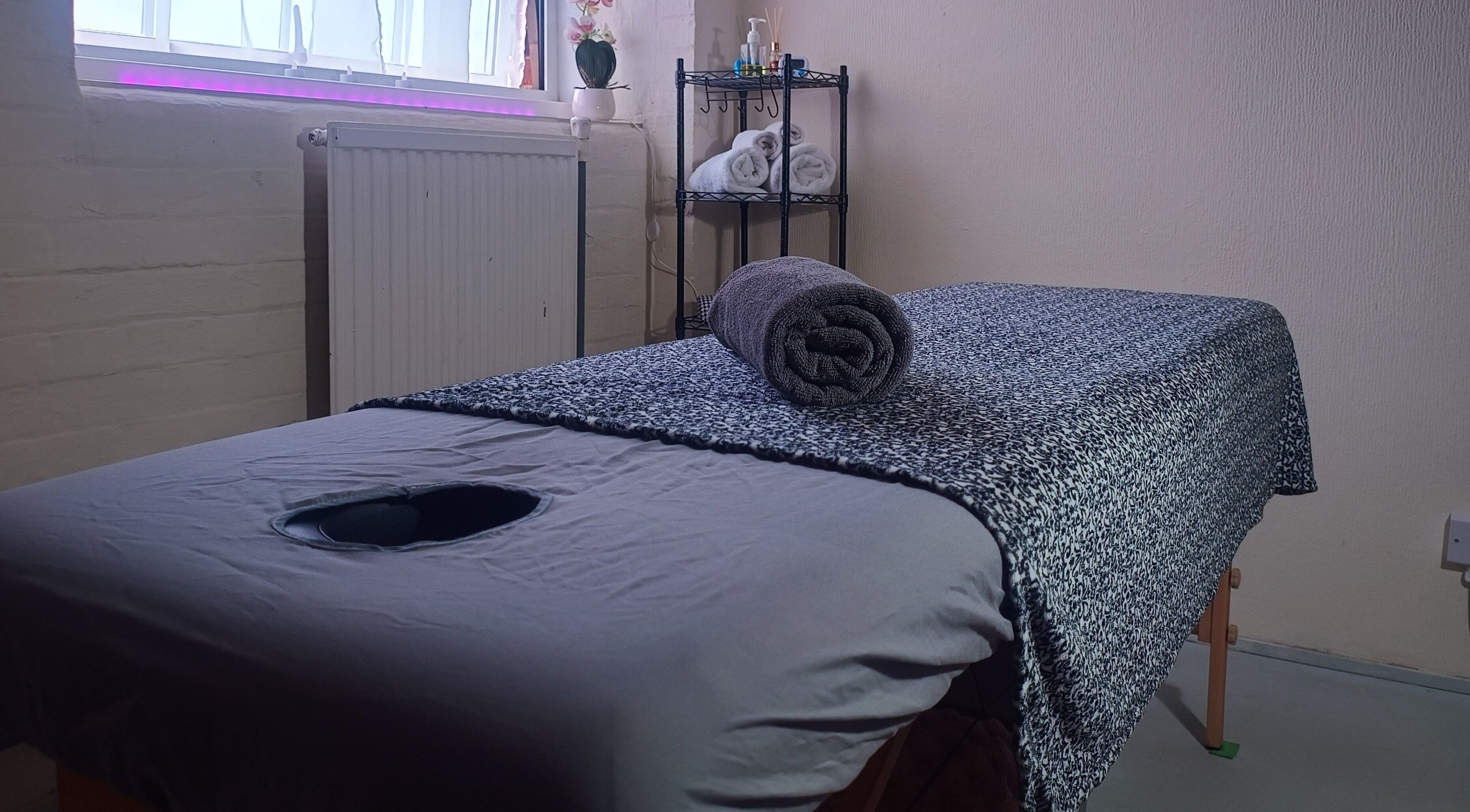 Relaxing massage table at The Rainbow Studio in Southampton, GB, with soothing decor and soft lighting.