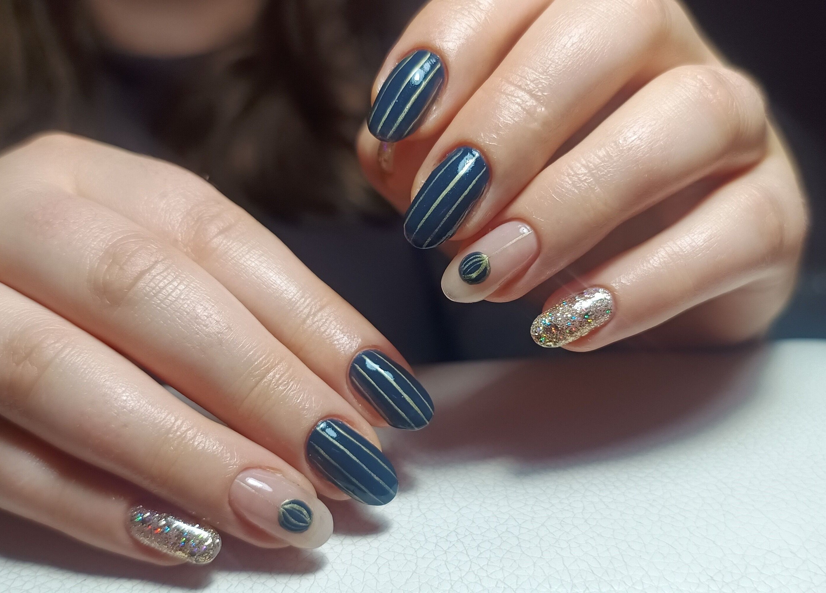 Stylish nail art with glitter and stripes at The Rainbow Studio, Southampton, GB.