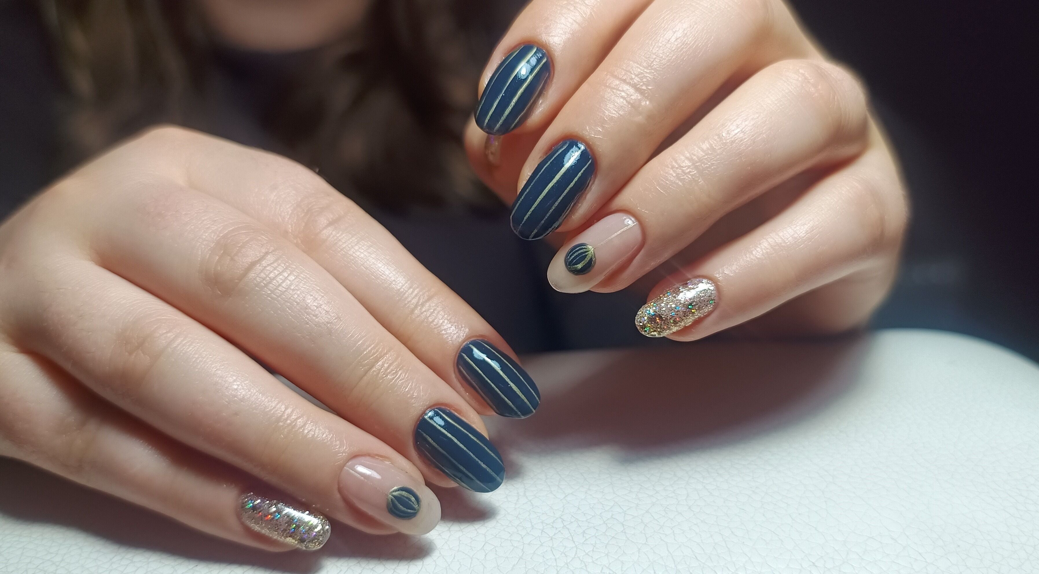 Stylish nail art with glitter and stripes at The Rainbow Studio, Southampton, GB.