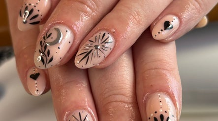 Elegant nail art at Danie Beauty in Hillsborough, England, GB, featuring intricate black and silver designs.