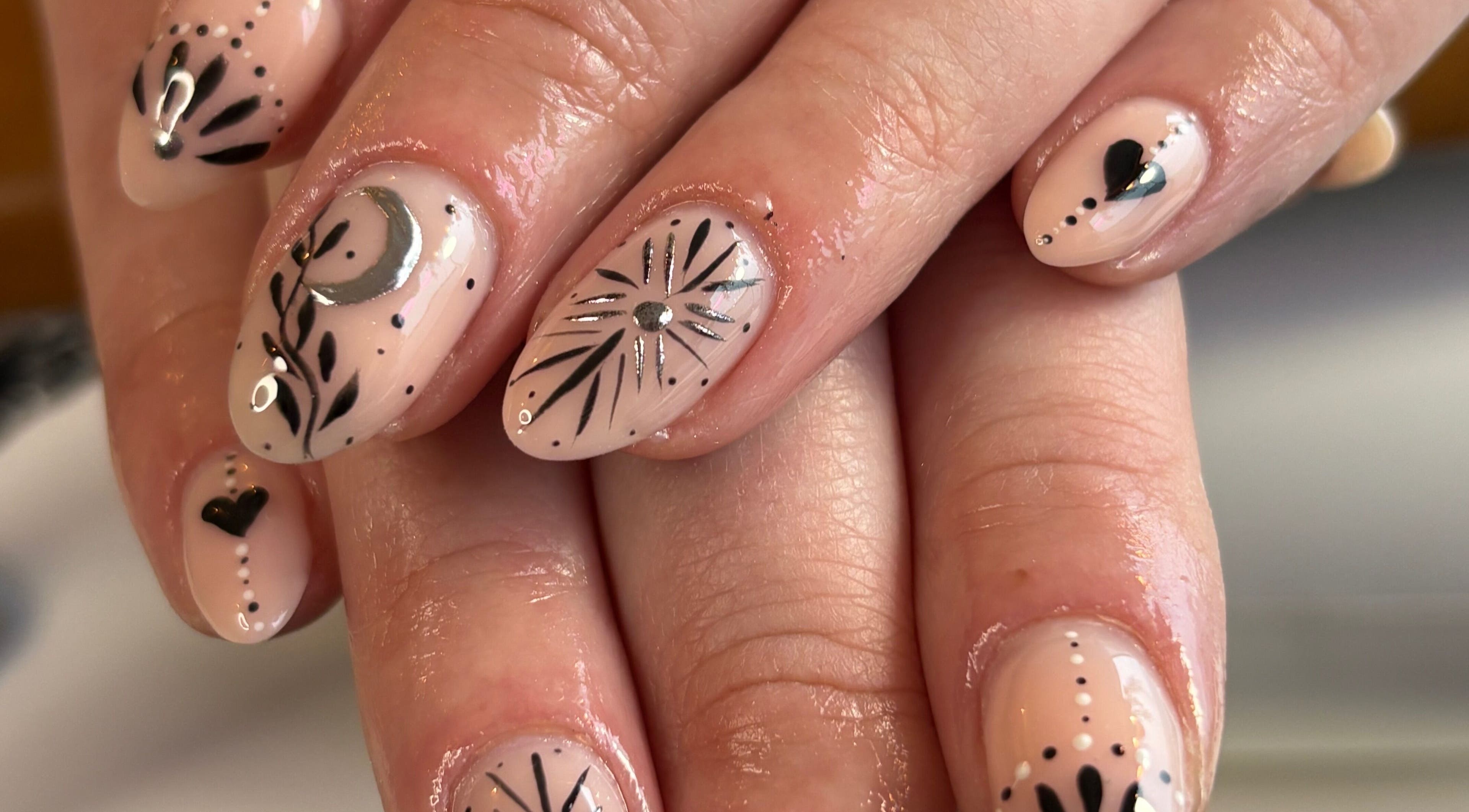 Elegant nail art at Danie Beauty in Hillsborough, England, GB, featuring intricate black and silver designs.