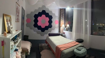Cozy massage room at Mindful Body Studio in Hickory Hills, Illinois, US with soothing decor and soft lighting.
