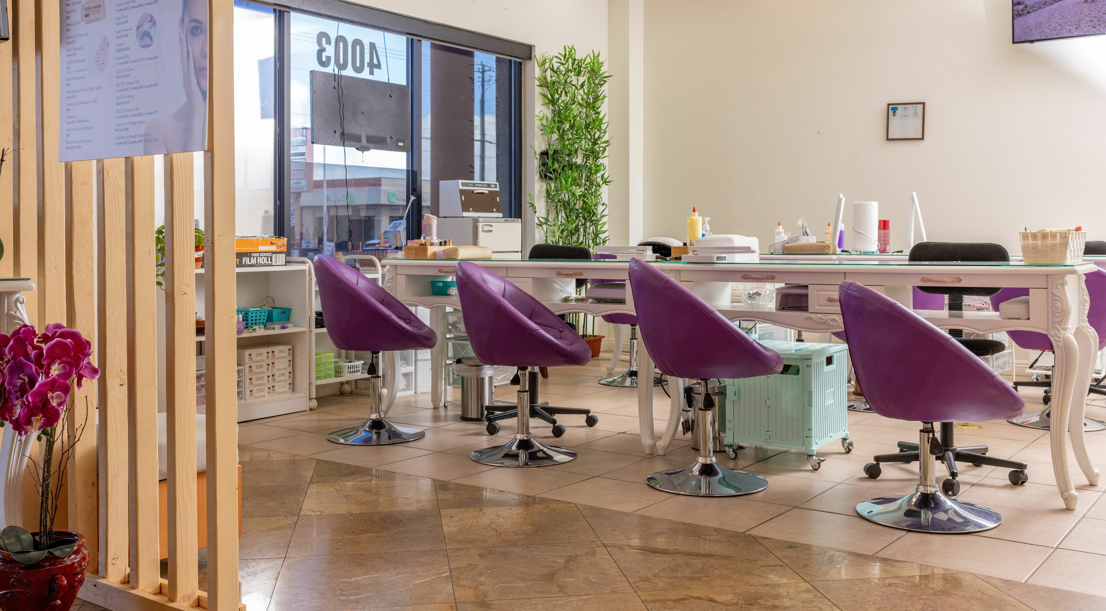 Stylish interior at KYOU Thai Massage and Beauty Spa in Las Vegas, Nevada, US with purple chairs and manicure stations.