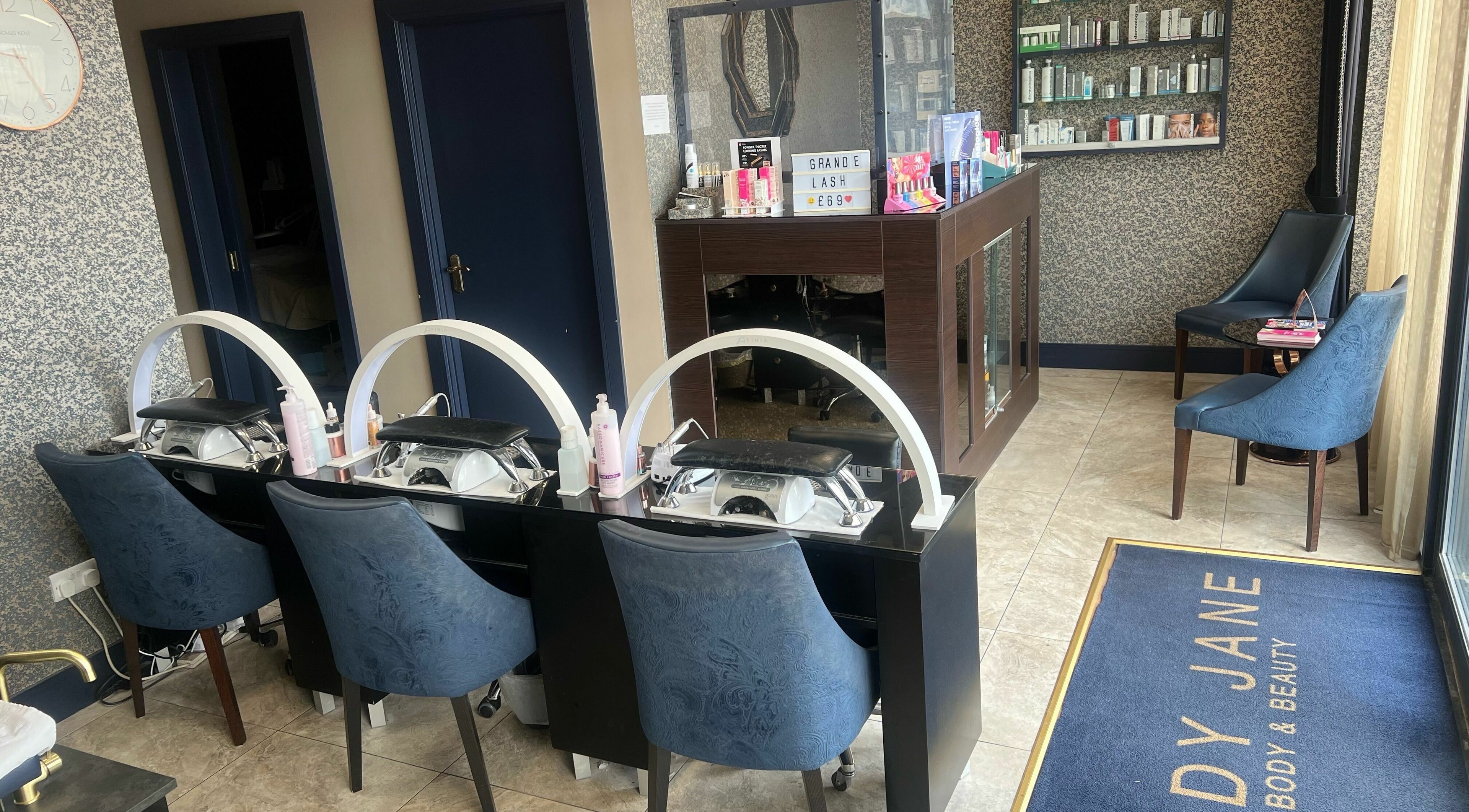 Interior of Lady Jane Body & Beauty in Killarney, County Kerry, IE showcasing stylish nail stations and seating area.