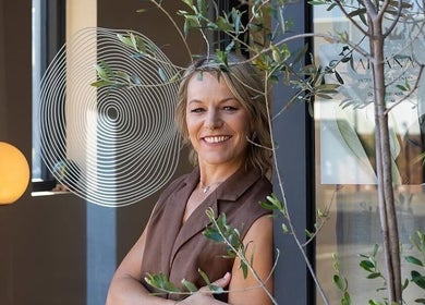 A welcoming professional at Aiyana Integrated Wellness, Toowoomba City, Queensland, AU, standing by a serene design.