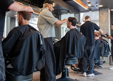 Stylists working at BAR x BAR Manly, New South Wales, AU, creating sleek haircuts for clients.