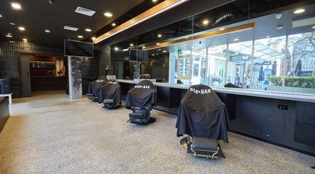 Modern salon interior at BAR x BAR Manly in Manly, New South Wales, AU with stylish seating and mirror decor.