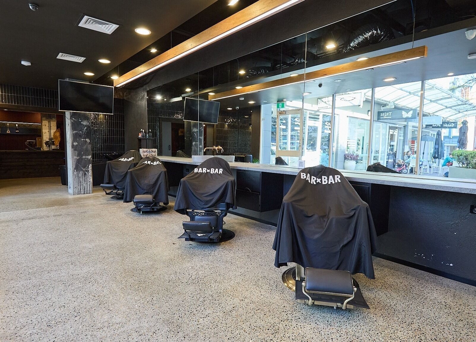 Spacious interior of BAR x BAR Manly, stylish barber chairs, Manly, New South Wales, AU.