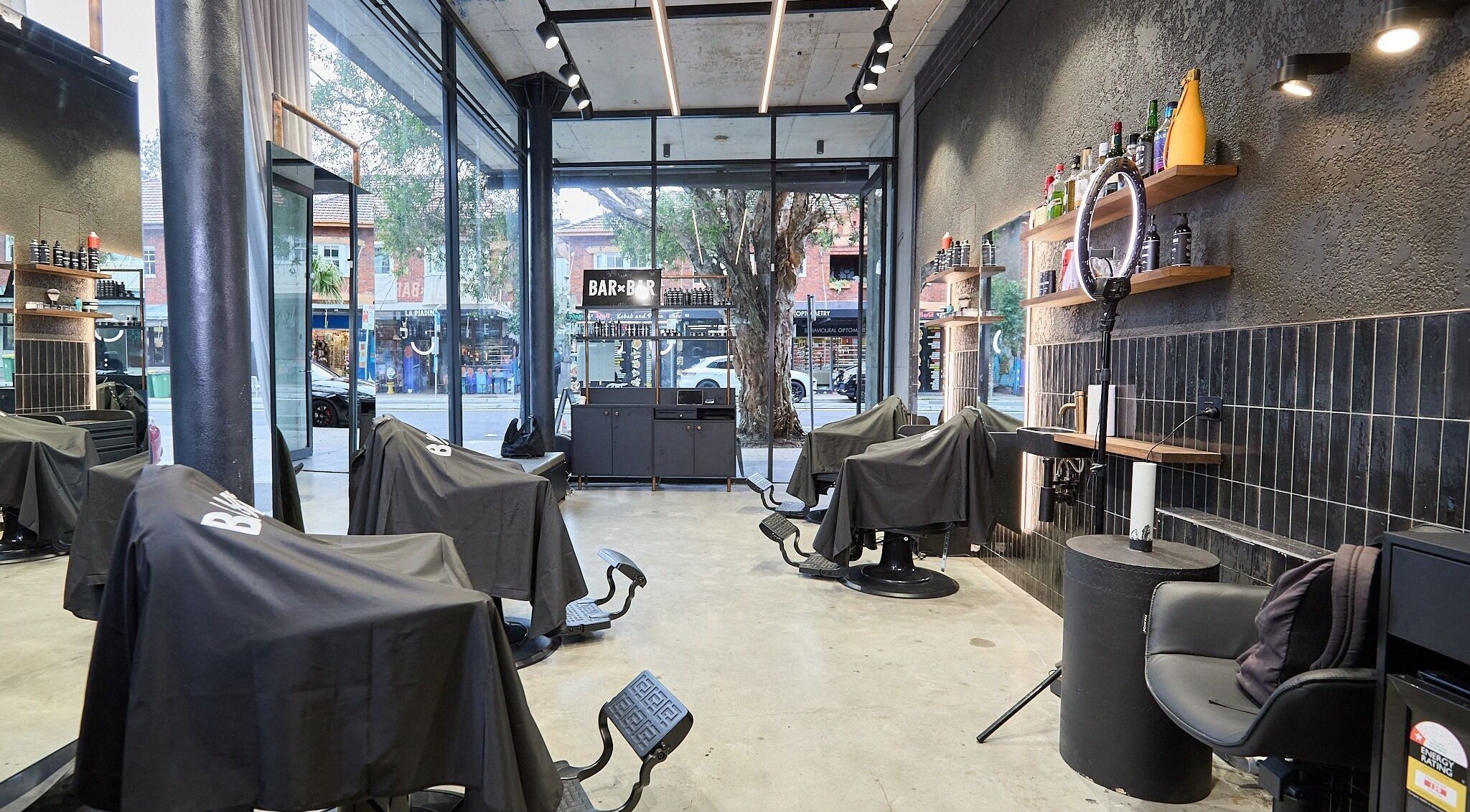 Modern barber chairs in BAR x BAR Bondi, located at Bondi Beach, New South Wales, AU.