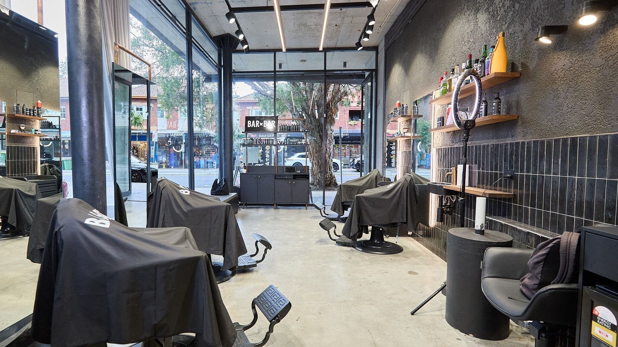 Modern barber chairs in BAR x BAR Bondi, located at Bondi Beach, New South Wales, AU.