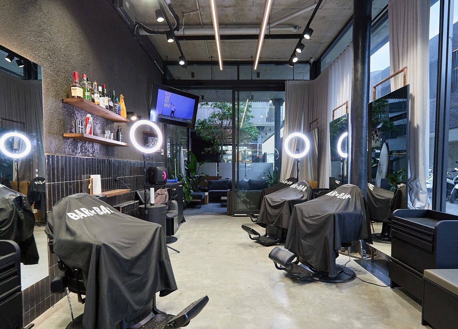 Interior of BAR x BAR Bondi at Bondi Beach, New South Wales, AU featuring sleek salon chairs and modern decor.