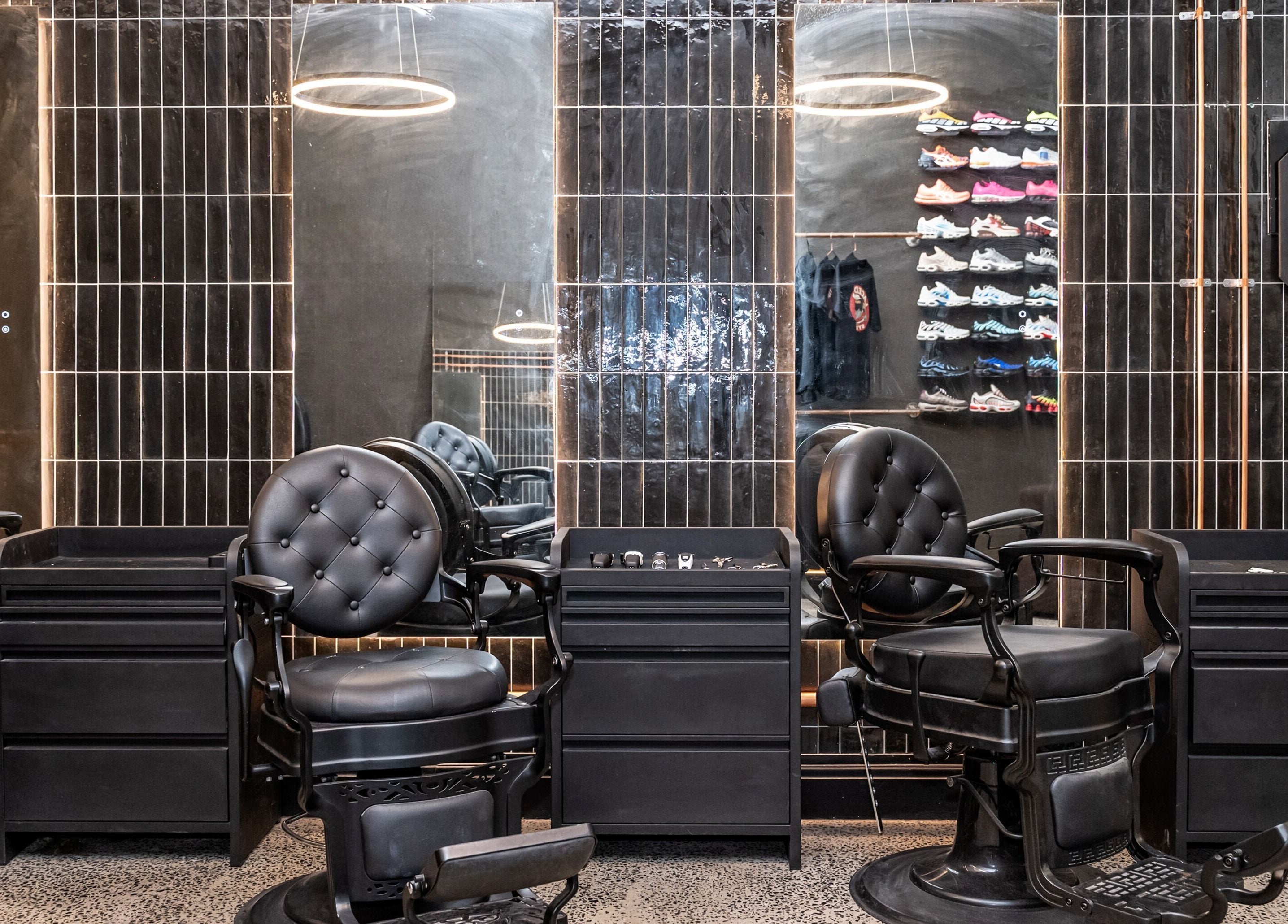 Stylish black barber chairs at BAR X BAR Freshwater, New South Wales, AU, offering a trendy grooming space.