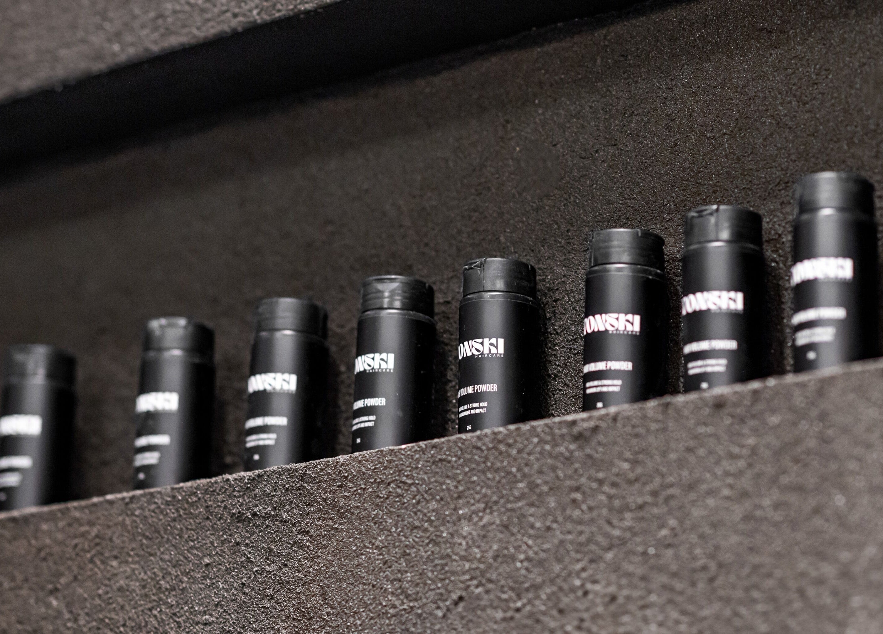 Stylish black product bottles on display at BAR X BAR Freshwater, Freshwater, New South Wales, AU.