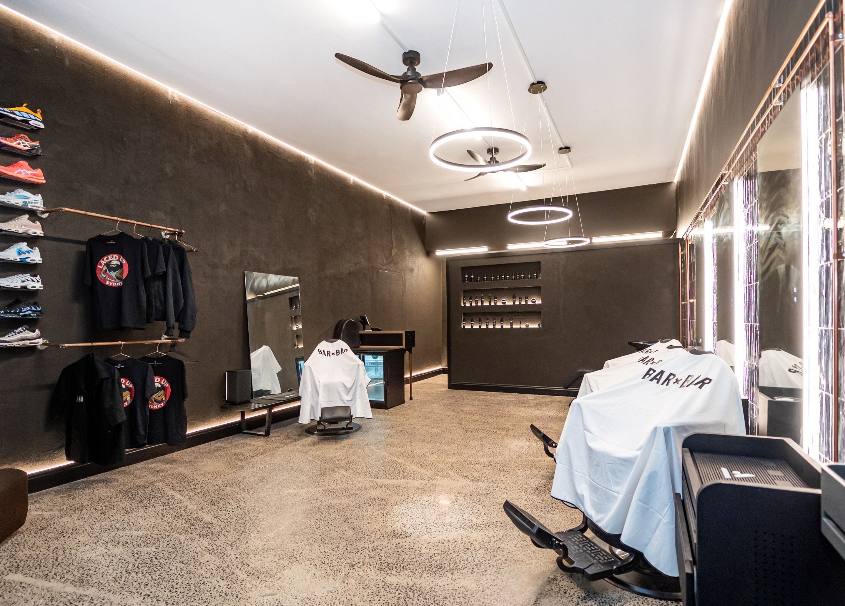 Modern interior of BAR X BAR Freshwater in Freshwater, New South Wales, AU, showcasing stylish barbershop design.