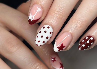 Stylish starry nail art at Aleita’s Beauty, Kilmarnock, Scotland, GB. Red and white design with dots and stars.