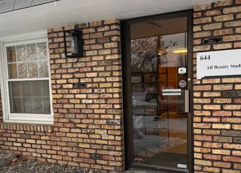 Entrance of AB Beauty Studio with brick facade in Wayzata, Minnesota, US.