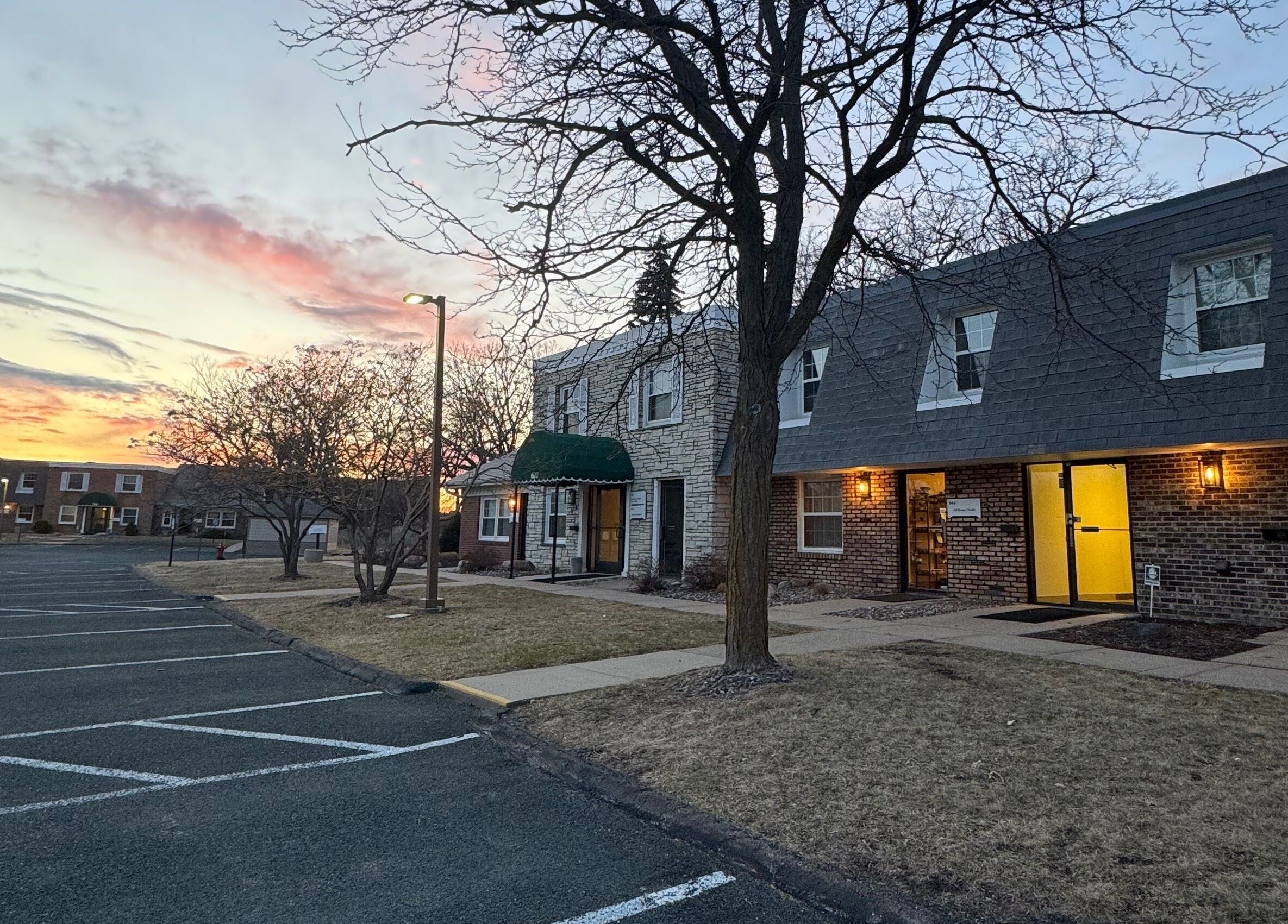 AB Beauty Studio in Wayzata, Minnesota, US at dusk, showcasing a peaceful parking area and inviting entrance.