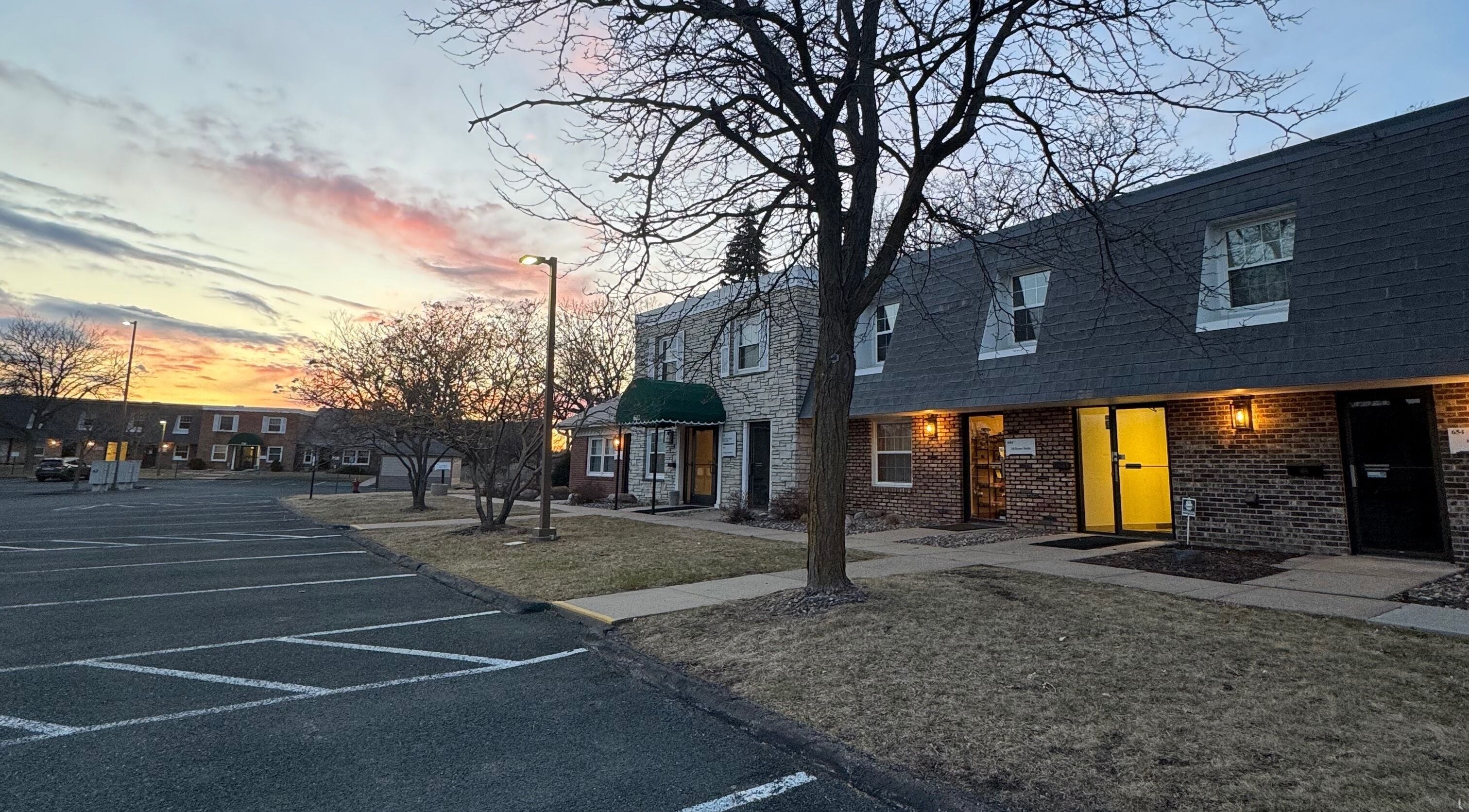 AB Beauty Studio in Wayzata, Minnesota, US at dusk, showcasing a peaceful parking area and inviting entrance.