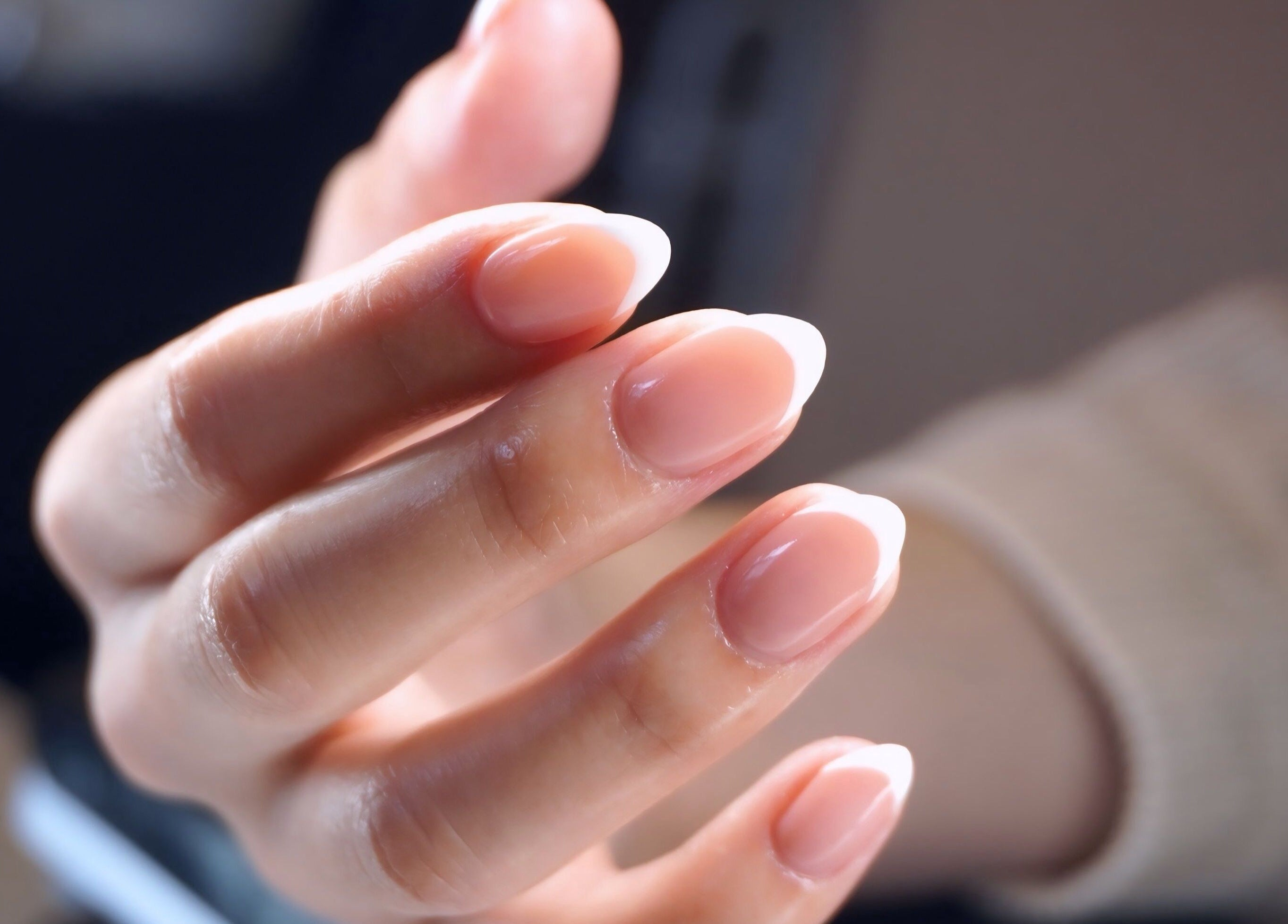 A hand with glossy, elegant nails at AB Beauty Studio, Wayzata, Minnesota, US.