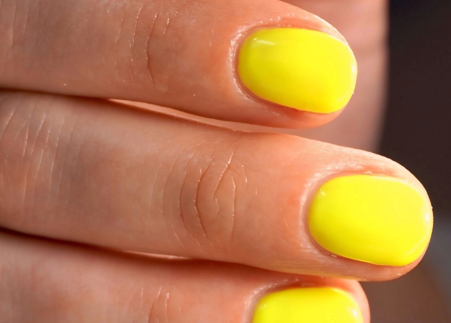 Close-up of vibrant yellow nails at AB Beauty Studio, Wayzata, Minnesota, US.