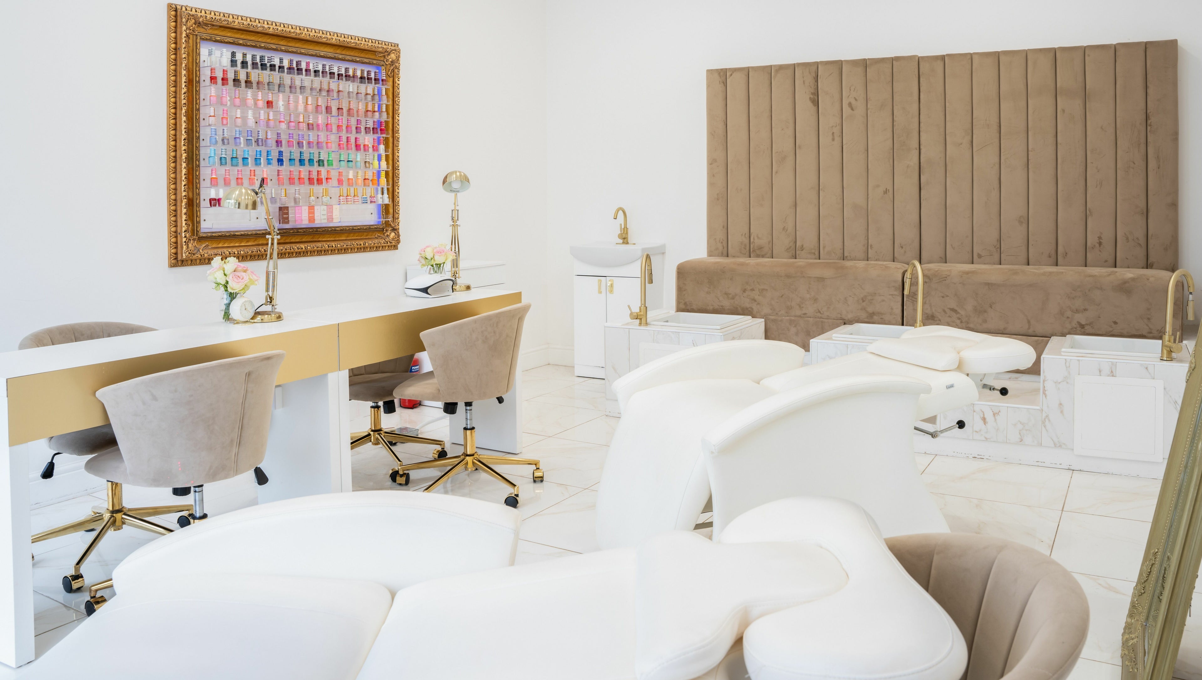 Chic interior of Lashes by Nadia, Chessington, England, GB with plush chairs and a nail polish display.