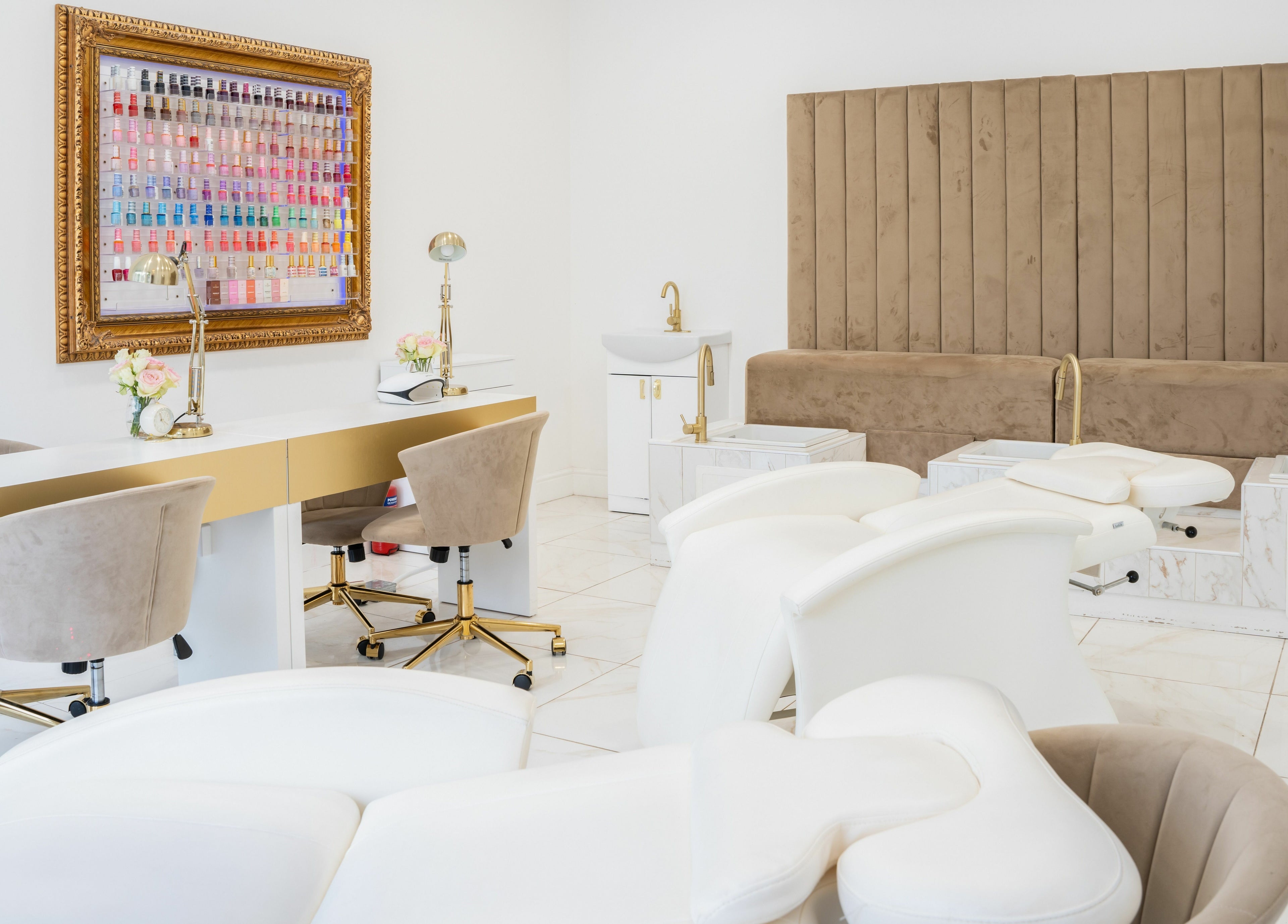 Chic interior of Lashes by Nadia, Chessington, England, GB with plush chairs and a nail polish display.