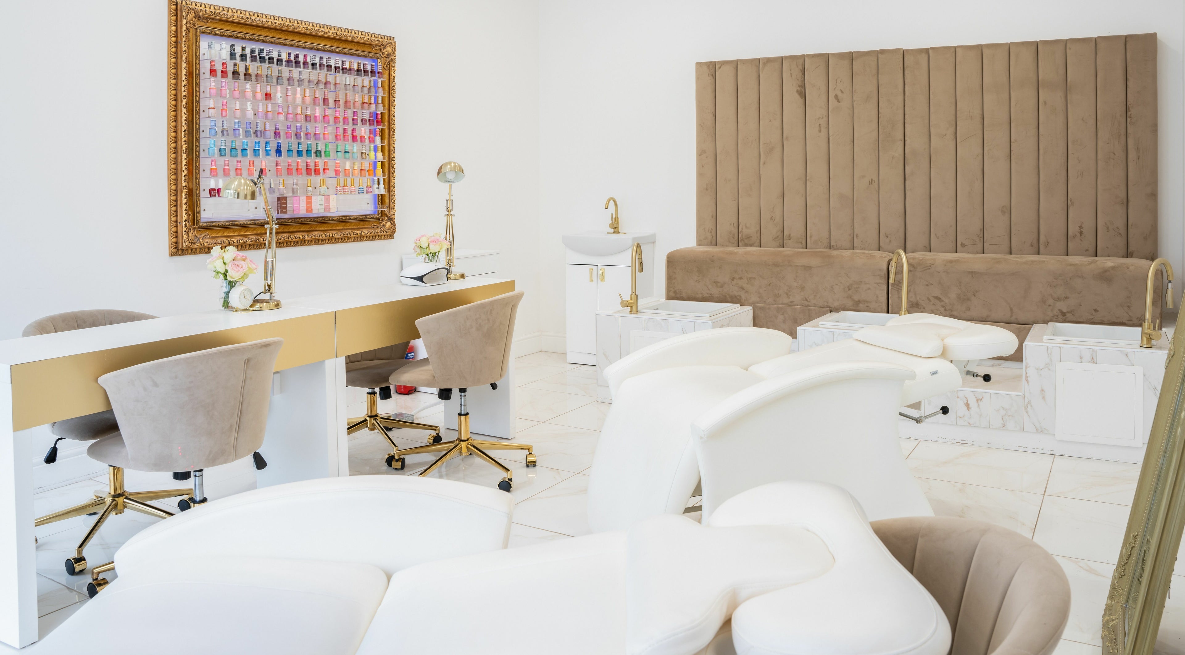Chic interior of Lashes by Nadia, Chessington, England, GB with plush chairs and a nail polish display.