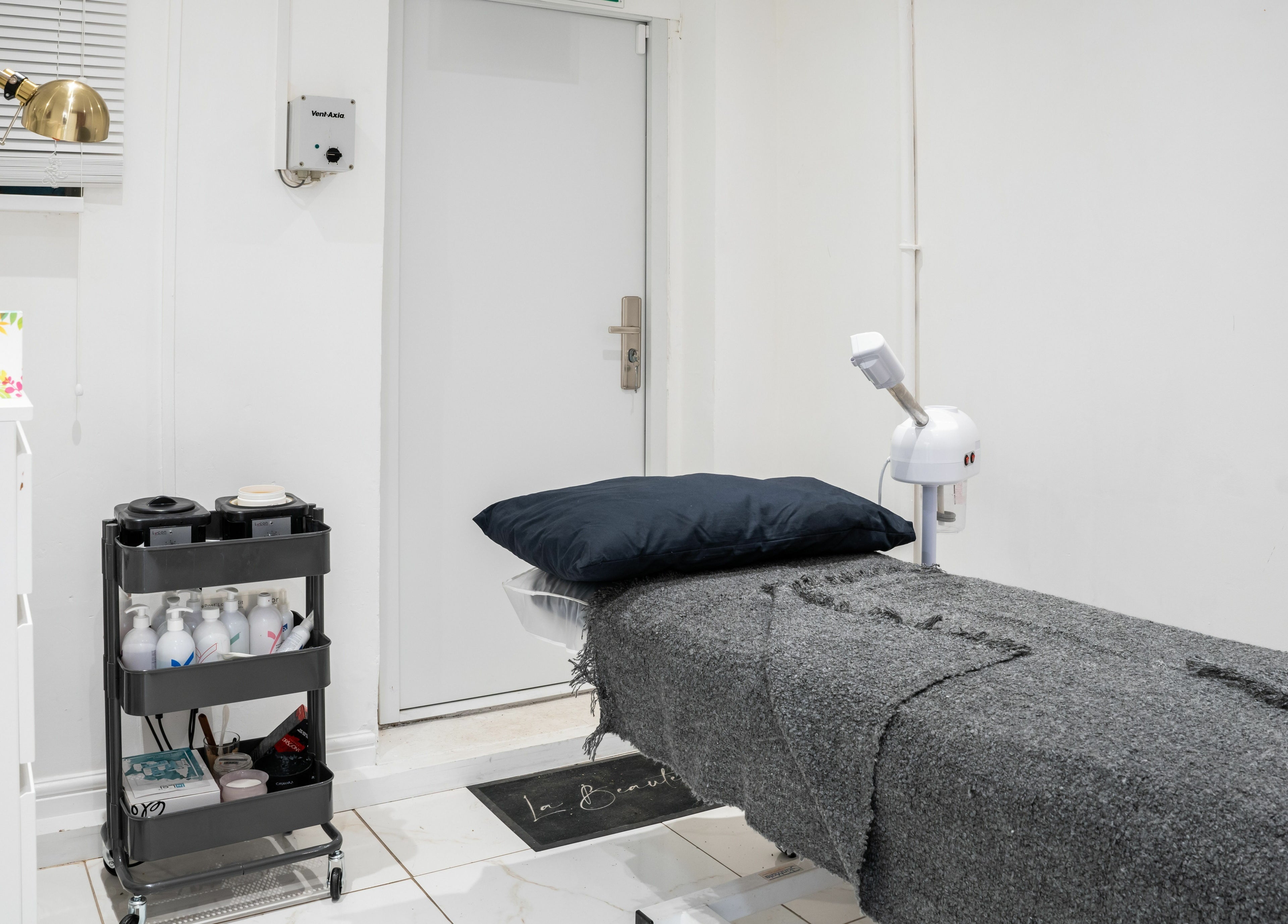 Relaxing treatment room at Lashes by Nadia, Chessington, England, GB, featuring a plush bed and modern decor.