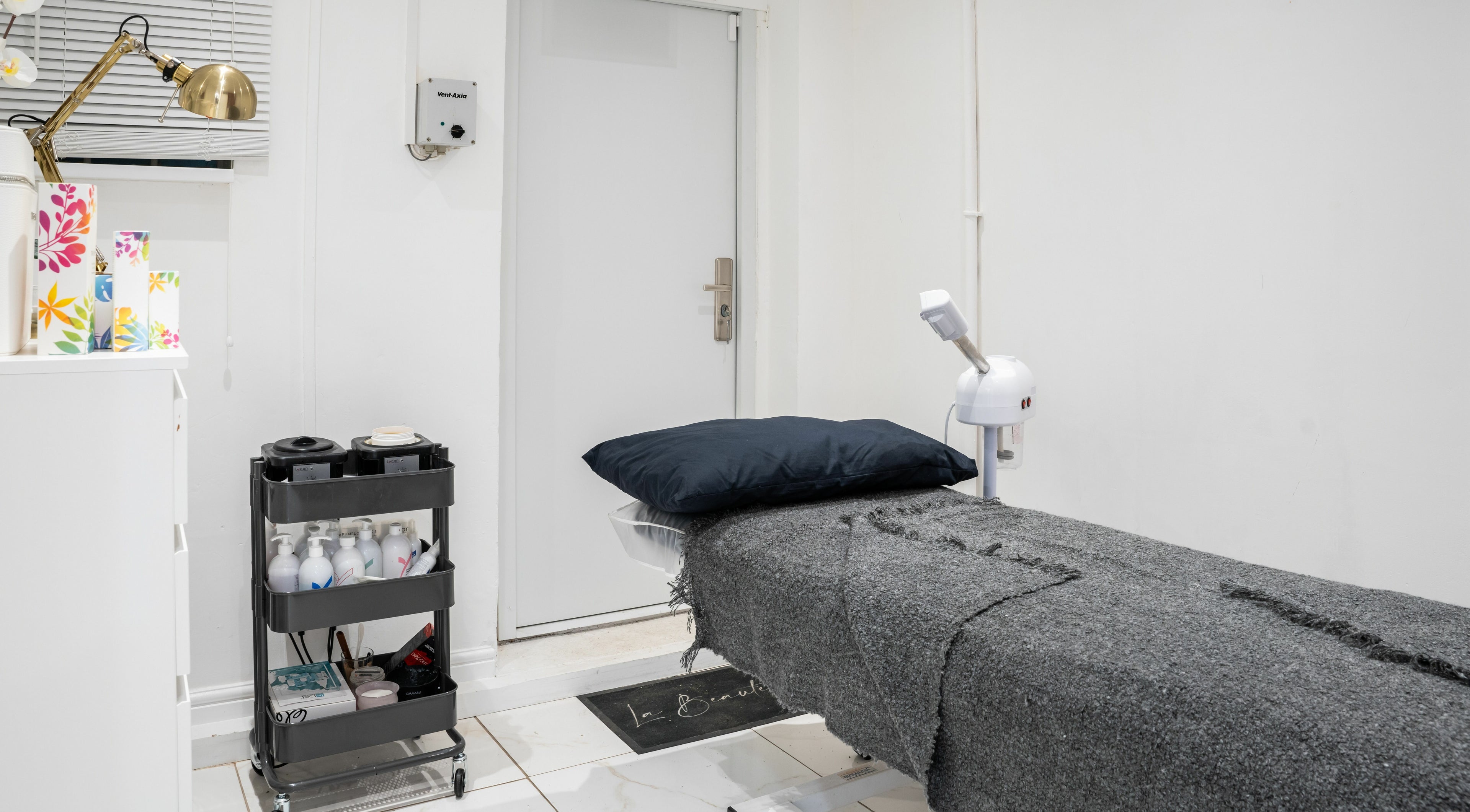 Relaxing treatment room at Lashes by Nadia, Chessington, England, GB, featuring a plush bed and modern decor.