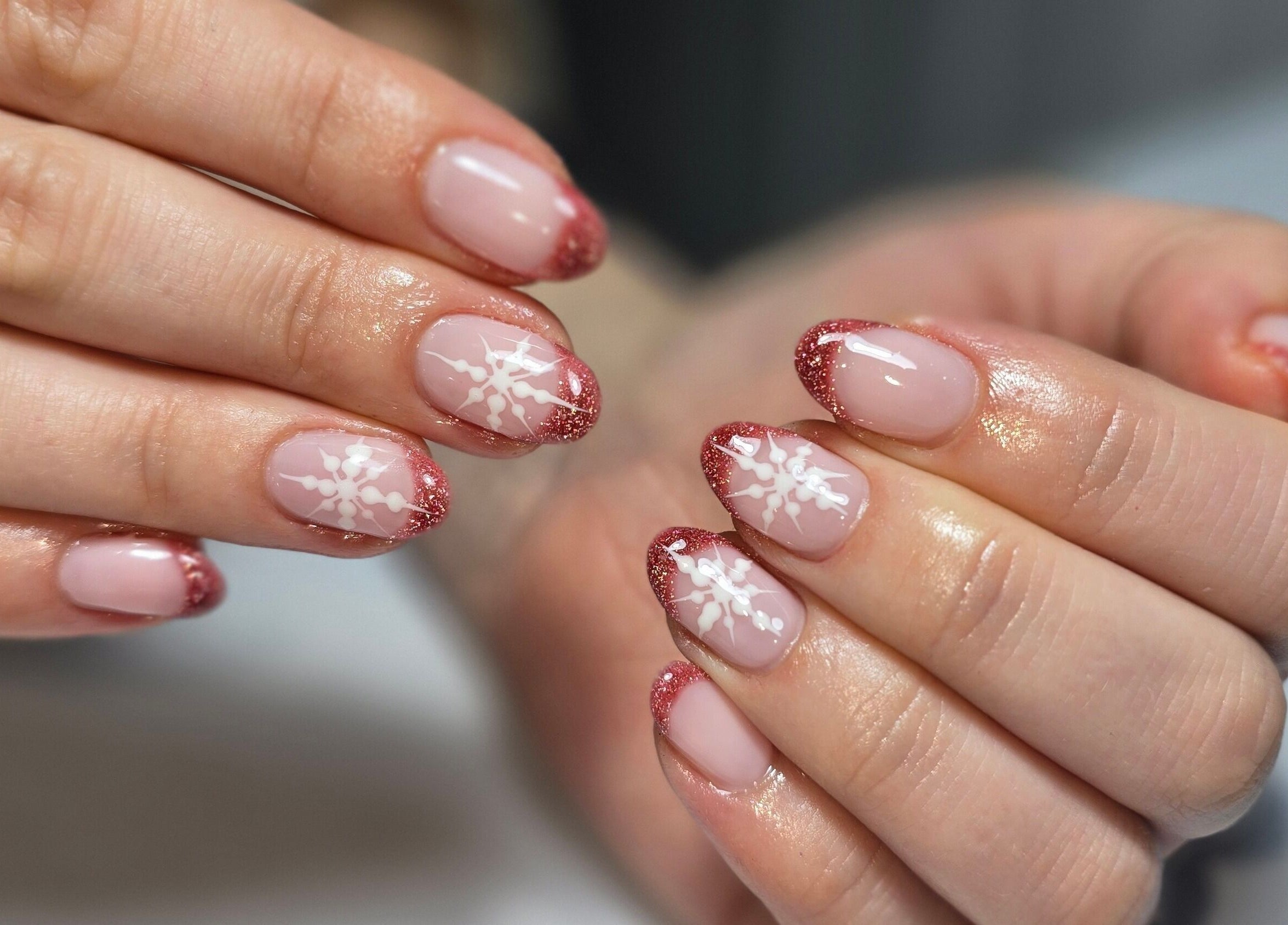 Elegant pink nails with snowflake designs at The Beauty Box, Rowley Regis, England, GB.