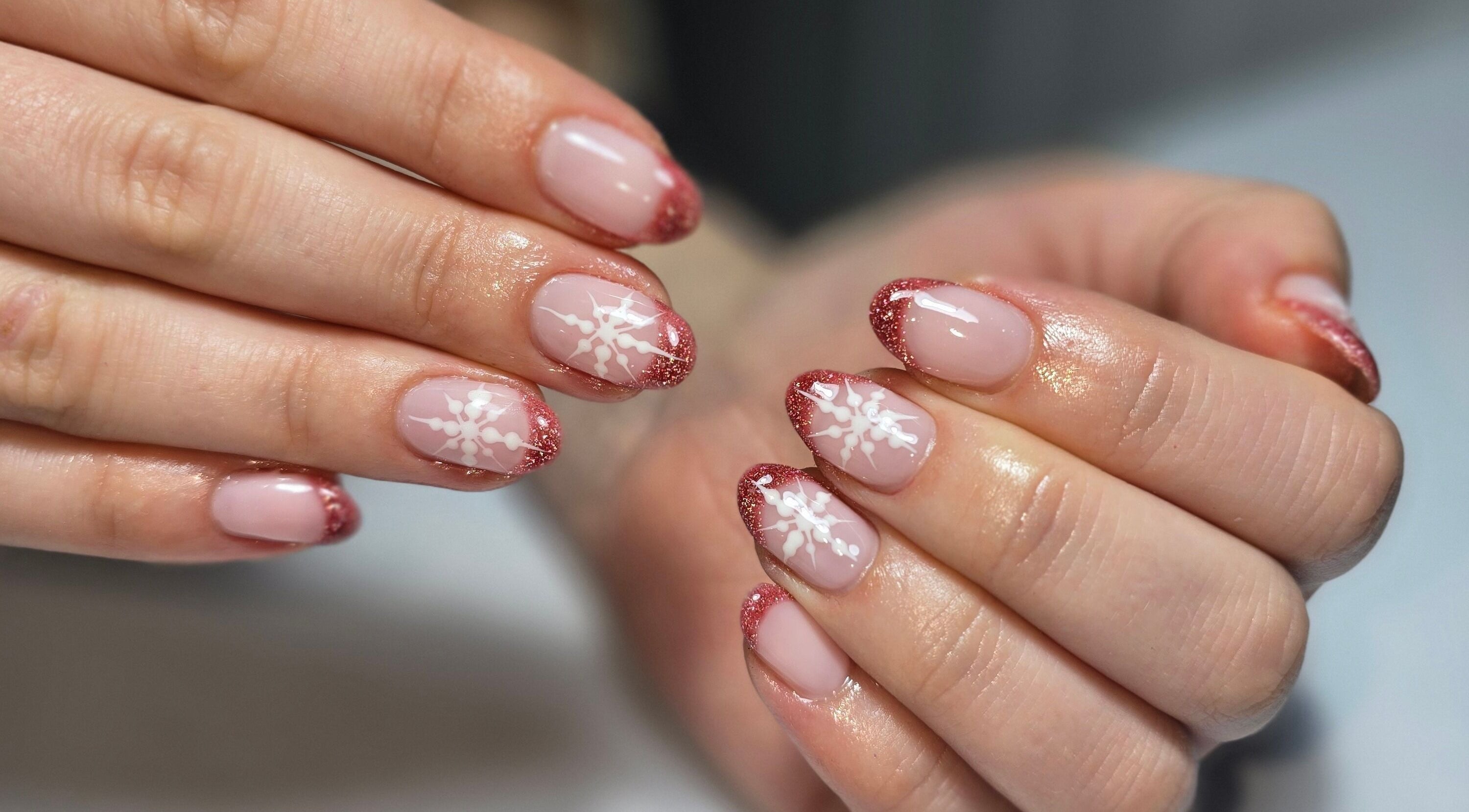 Elegant pink nails with snowflake designs at The Beauty Box, Rowley Regis, England, GB.