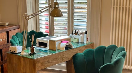 Luxurious nail station at Chapter1 Salon, Cheltenham, England, GB with plush green chairs and modern design.