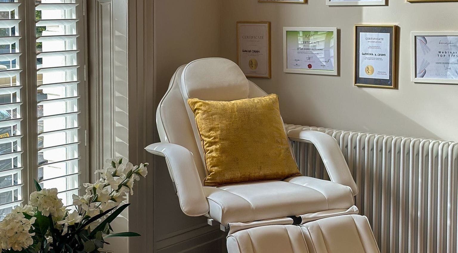 Relaxing chair in treatment room at Chapter1 Salon, Cheltenham, England, GB featuring certificates and decor.